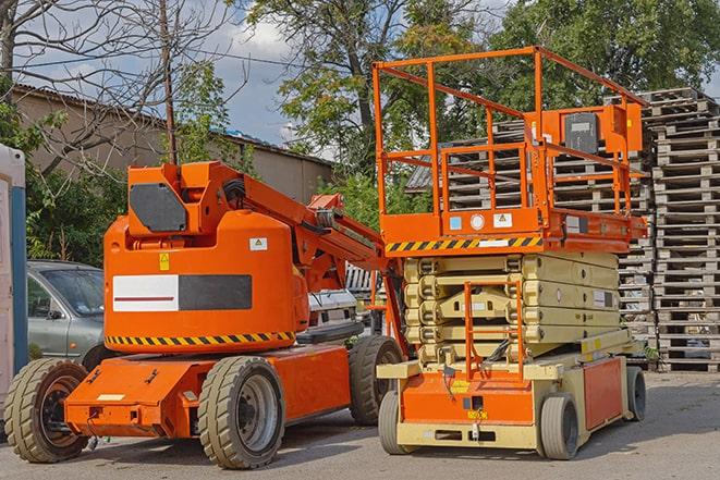 forklift carrying pallets in a busy warehouse in Cooper City